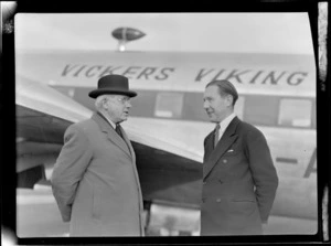 Portrait of Prime Minister Peter Fraser (left) and Mr P Roberts (pilot) in front of visiting British Vickers Viking passenger plane G-AJJN, location unknown