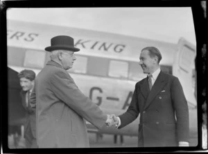 Portrait of Prime Minister Peter Fraser (left) and Mr P Roberts (pilot) in front of visiting British Vickers Viking passenger plane G-AJJN, location unknown