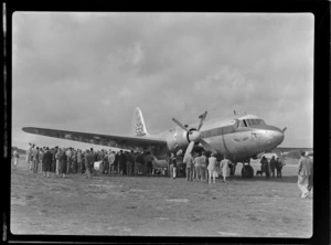 View of unidentified people inspecting the visiting British Vickers Viking passenger plane G-AJJN at Paraparaumu Airfield, Wellington Region