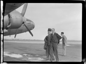 View of Colonel W C Salmon with unidentified men in front of visiting British Vickers Viking passenger plane G-AJJN, location unknown
