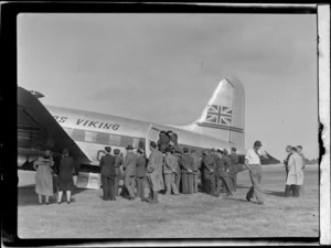 View of unidentified people inspecting the visiting British Vickers Viking passenger plane G-AJJN at Paraparaumu Airfield, Wellington Region