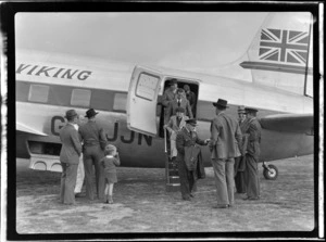 Group Captain White, Mr and Mrs Scott and Mr Gibson being greeted by unidentified people after demonstration flight aboard visiting British Vickers Viking passenger plane G-AJJN, Paraparaumu Airfield, Wellington Region