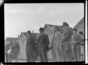 NZ NAC (National Airways Corporation) officials Mr J Gardiner (left) and Mr Johnson (right) with unidentified people during an open-day to view visiting British Vickers Viking passenger plane G-AJJN at Paraparaumu Airfield, Wellington Region