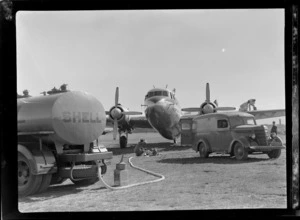 Visiting British Vickers Viking passenger plane G-AJJN being refuelled from a Shell Oil truck by unidentified men at Paraparaumu Airfield, Wellington Region