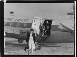 Unidentified passengers disembarking from demonstration flight aboard visiting British Vickers Viking passenger plane G-AJJN at Paraparaumu Airfield, Wellington Region