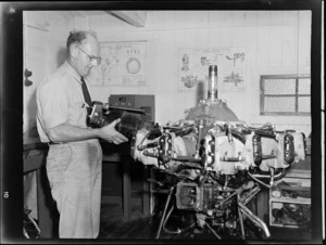 Unidentified man working with aircraft engine at the Auckland Aero Club