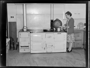 Unidentified woman cooking on AGA Cole range at the Auckland Aero Club