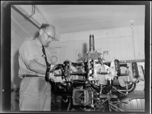 Unidentified man working with aircraft engine at the Auckland Aero Club