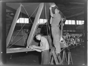 Two unidentified men working on Tiger Moth aircraft at the Auckland Aero Club