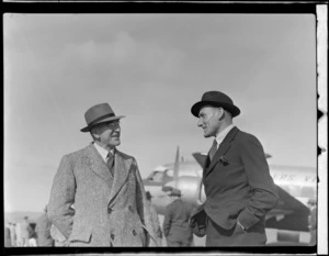 Portrait of (L to R) Mr N H Smith - General Manager Shell Oil Co. NZ, Mr P Castle of Shell Oil in front of visiting British Vickers Viking passenger plane G-AJJN, location unknown