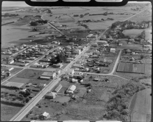 The town of Otaki with the Ford Service garage on Main Street and houses surrounded by field crops and farmland, Kapiti Coast, Wellington Region