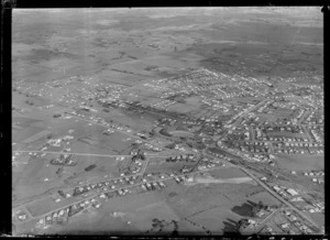 Passenger Transport Company coverage with general views over an outer unidentified [Auckland?] suburb with train station, sports ground and houses, surrounded by farmland