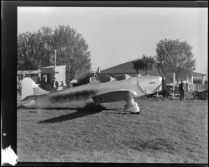 View of a Miles Magister aeroplane ZK-ALO and unidentified Otago Aero Club members at an unknown airfield, Otago Region
