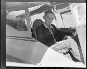 Portrait of [Marlborough Aero Club member?] John Wright sitting in Auster J-1B Autocrat ZK-AOB passenger plane, location unknown, Marlborough Region