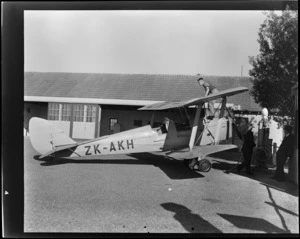 View of Otago Aero Club De Havilland DH 82A Tiger Moth ZK-AKH being refuelled by unidentified men, Otago Region