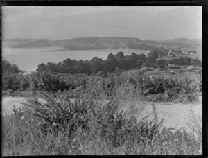Stanmore Bay, Whangaparaoa, Auckland, showing a road, looking towards the beach and township