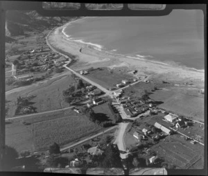 Tokomaru Bay coastal settlement and Waitangi Street with church and graveyard and Hatea A Rangi Primary School rugby field in foreground, Gisborne Region