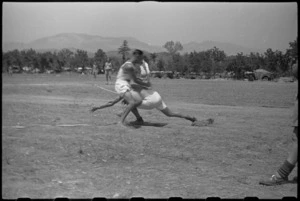 Action shot in softball game between 28 and 27 Batteries at 5 Field Regiment Gymkhana, Arce, Italy, World War II - Photograph taken by George Bull