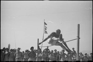 Sergeant W N Leonard competing in high jump event at 5 NZ Field Regiment Gymkhana, Arce, Italy, World War II - Photograph taken by George Bull