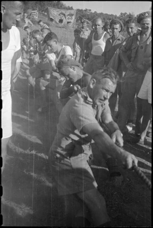 Members of 27 Battery put their weight into tug-of-war event at 5 NZ Field Regiment Gymkhana, Arce, Italy, World War II - Photograph taken by George Bull