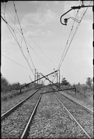 Twisted overhead rail wires left by retreating Germans near Terontola, Italy, in World War II - Photograph taken by George Kaye
