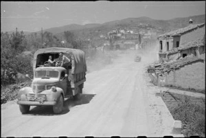 New Zealand Division truck moving to forward areas with Italian town of Castiglion Fiorentino in background, World War II - Photograph taken by George Kaye