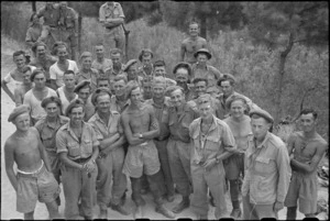 Members of 26 New Zealand Battalion who took part in attack on Mt Lignano, Italy, awaiting transport to rear rest area - Photograph taken by George Kaye
