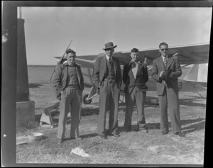 Timaru personalities, next to an Auster airplane, showing (L to R), D Greig, Mac ?, Harry L Wigley and an unidentified man, Timaru