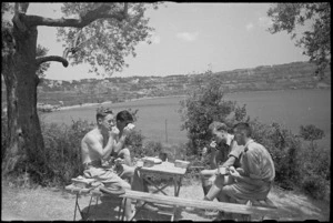 Personnel having lunch at NZ Divisional HQ picnic on shores of Lake Albano near Rome, Italy - Photograph taken by George Kaye
