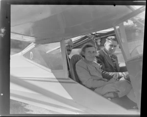 D Greig (left) and unidentified elderly woman and a man, in an Auster airplane, Sherwood Downs, Fairlie, Canterbury Region
