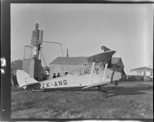 H Wigley's DH Moth ZK-ANG airplane refuelling, location unidentified