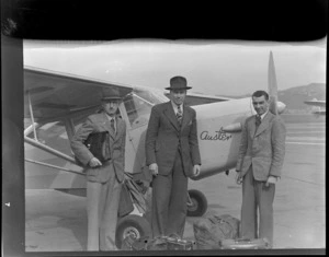 Auster tours, (L to R), T Ewart, D Greig and Leo Lemuel White, next to an Auster airplane, Rongotai airport, Wellington
