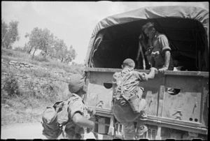 World War II New Zealand Infantry troops climbing onto truck for transport to rear after assault on Lignano, Italy - Photograph taken by George Kaye