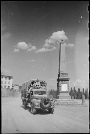 New Zealand Infantry passes Garibaldi Memorial Needle in Castiglione square, Italy, World War II - Photograph taken by George Kaye
