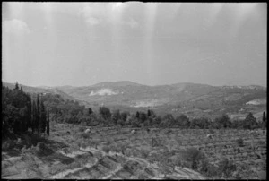 Looking towards enemy held town of San Casciano with dust from shell bursts visible, Italy, World War II - Photograph taken by George Kaye