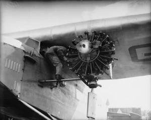 Man working on one of engines of the aeroplane "Southern Cross"