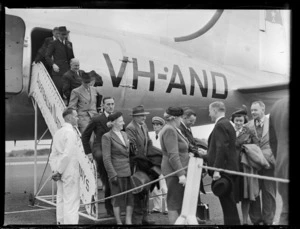 Passengers, all unidentified, disembarking a Douglas Skymaster DC-4 aeroplane, 'Tatana', VH-AND, chartered by British Commonwealth Pacific Airlines from Australian National Airways, after arrival from Melbourne [at Whenuapai Airport, Auckland?]