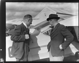 Mr J Jones and Mr R Leask, looking at an airplane, at Invercargill Airport