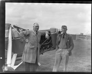 Mr D Harris (right) and Mr A J McIntosh, standing next to de Havilland DH-80A Puss Moth ZK-AJW, Invercargill Airport