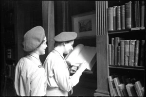Off duty Tuis, Miss H E Duxfield and Miss N R Webley, sign their names in the visitors book at the Keats House in Rome, Italy, World War II - Photograph taken by George Kaye