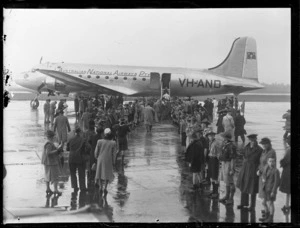 Opening of British Commonwealth Pacific Airlines' trans Pacific service, showing crowd gathered on tarmac alongside Douglas Skymaster DC-4, 'Tatana', VH-AND, chartered from Australian National Airlines, Whenuapai Airport, Auckland