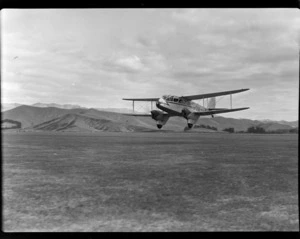 Aircraft ZK-AKY de Havilland D.H.89B Dragon Rapide 'Tui', flying, at Omaka Airport, Blenheim, Marlborough district