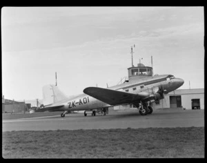 Aircraft ZK-AOI Douglas DC-3 'Dakota', next to control tower, at Harewood Aerodrome (Christchurch International Airport)