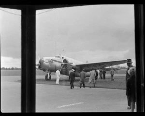 Passengers and crew member boarding aircraft Lockheed Lodestar ZK-AIQ 'Kotuku', probably at Whenuapai Airbase, Auckland