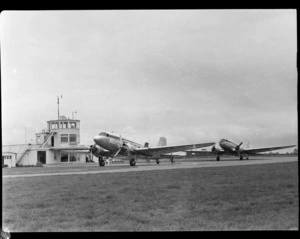 Two Douglas DC-3 Dakota aeroplanes, including the control tower in the background, at Harewood Aerodrome (Christchurch International Airport)