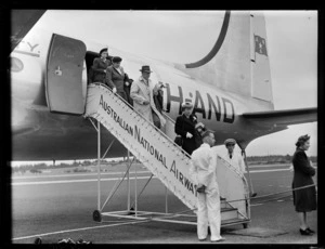 Passengers, all unidentified, disembarking Douglas DC-4 Skymaster aeroplane 'Tatana' VH-AND, chartered by British Commonwealth Pacific Airlines, at Whenuapai Airport, Auckland