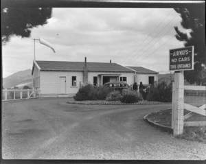Unidentified people outside the NZ NAC ((National Airways Corporation) waiting room building at Omaka Airport, Blenheim, Marlborough Region