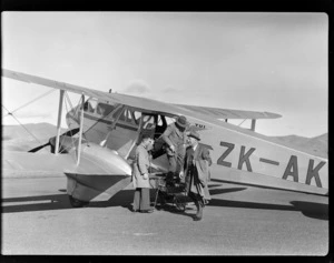Three unidentified men disembarking the NZ NAC (National Airways Corporation) De Havilland Dominie 'Tui' bi-plane ZK-AKY at Omaka Airport, Blenheim, Marlborough Region