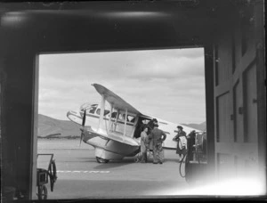 NZNAC (New Zealand National Airways Corporation) passengers deplaning from a Rapide ZK-ALC 'Tiora' airplane, Omaka, Blenheim