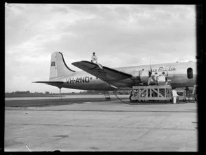 Douglas DC-4 Skymaster aeroplane 'Tatana' VH-AND, chartered by British Commonwealth Pacific Airlines, being refueled, at Whenuapai Airport, Auckland